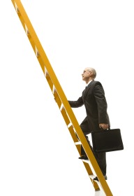 Businessman climbing ladder.