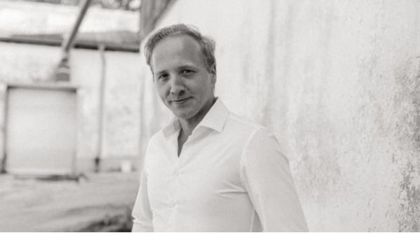 Bild von Felix Haupt in schwarz-weiß vor einer Wand.